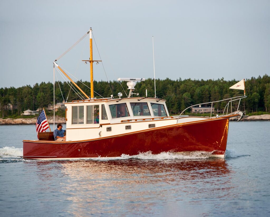 A red hull lobster yacht cruising in calm water