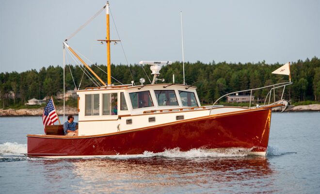 A red hull lobster yacht cruising in calm water