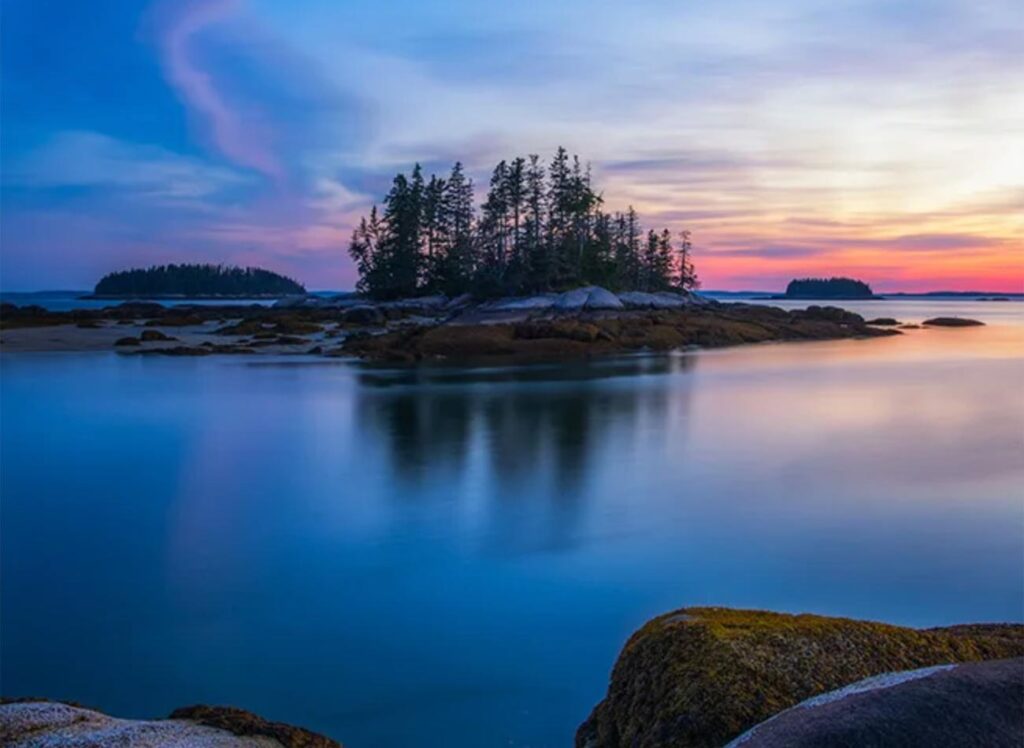 Sunset, calm water and the islands on the Maine Island Trail