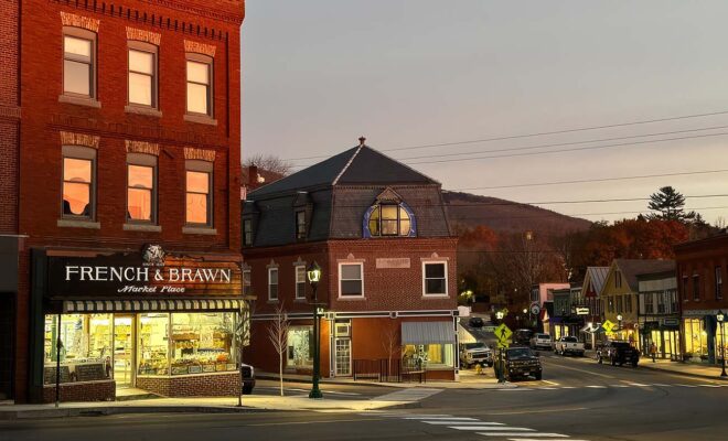 A view downtown in Camden Maine showing the French and Brawn market at the intersection.