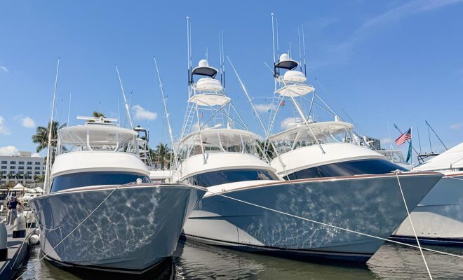 Three sport fishing boats tied up at a boat show