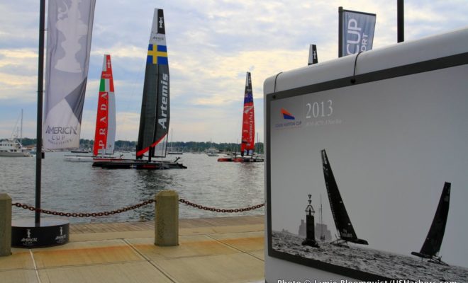 AC45 catamarans sit at their moorings alongside the race village at Fort Adams