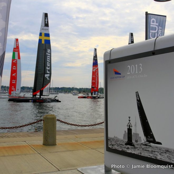 AC45 catamarans sit at their moorings alongside the race village at Fort Adams