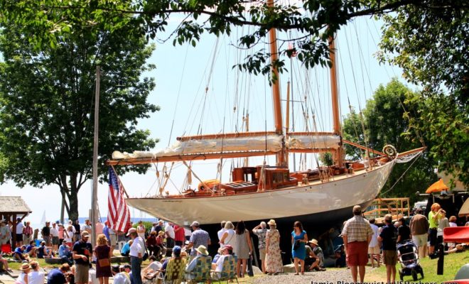 Adventuress sits ready for launch. Rockport Harbor filled with people in anticipation.