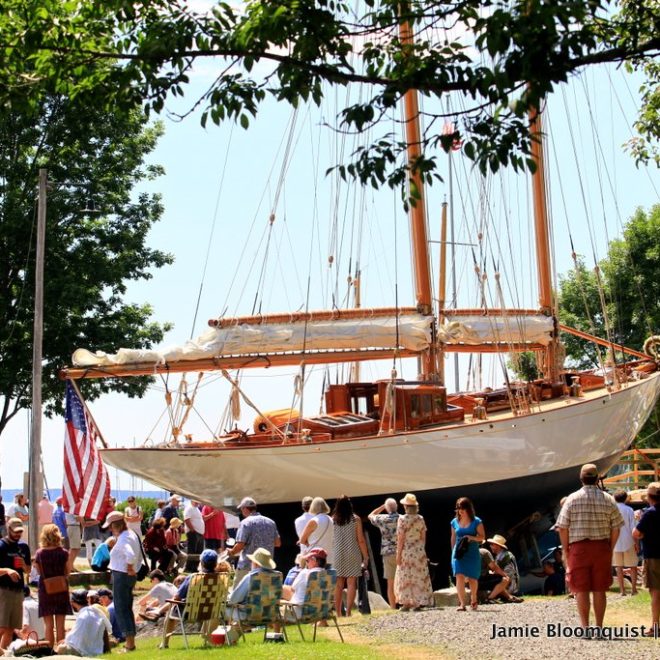 Adventuress sits ready for launch. Rockport Harbor filled with people in anticipation.