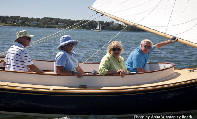 The crew aboard PAWS, a 16' open Arey's Pond catboat, are all smiles during the 2015 Catboat Gathering.