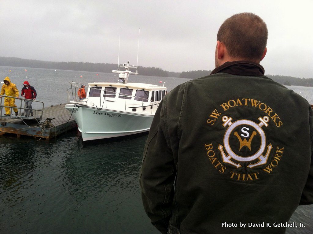 One of the SW Boatworks crew surveys the latest floating embodiment of their motto: "Boats That Work."