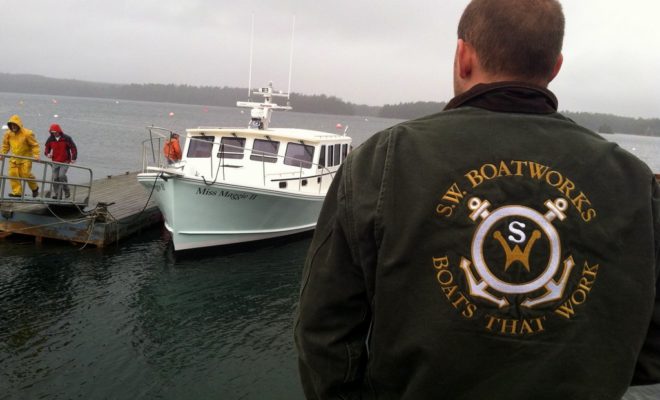 One of the SW Boatworks crew surveys the latest floating embodiment of their motto: "Boats That Work."