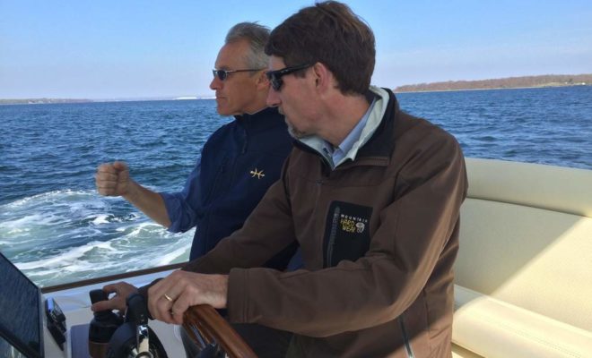 Hunt Yachts' Greg Weatherby, at left, explains the power of the Yamaha Helm Master joystick outboard control.