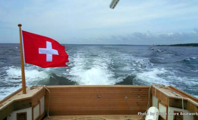 TWIST always flies her Swiss flag proudly. Note the teak work on the dropdown transom.