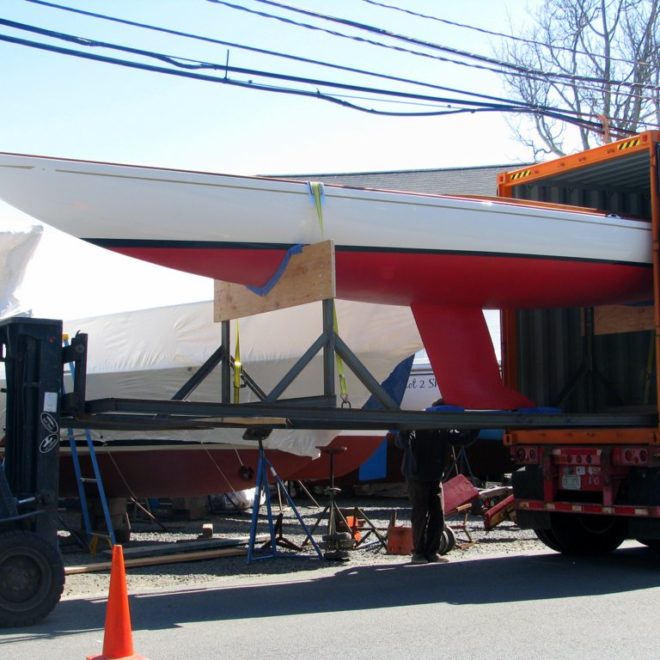 Baby J, a C.W. Hood 32 daysailer, is loaded into a container in Marblehead, bound for Europe.