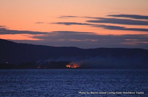 Flames on the north side of Lassell Island are visible from North Haven on April 14.