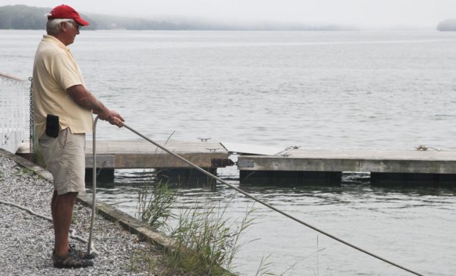 Cabot Lyman, owner of Lyman-Morse Boatbuilding Co., tends the lines as MOONWAVE is hauled.