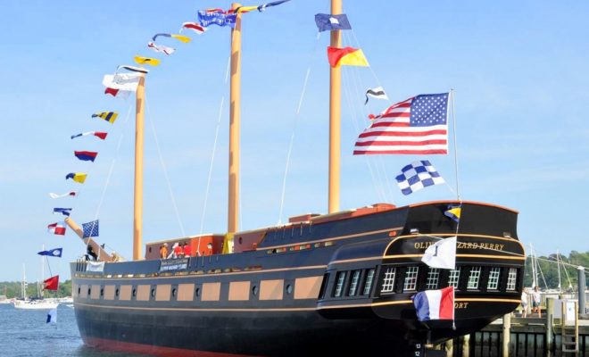 The OLIVER HAZARD PERRY flies its colors during the dedication ceremonies. When completed, the masts will be triple this size.