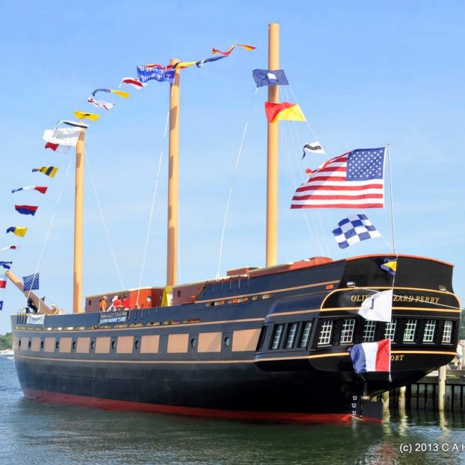 The OLIVER HAZARD PERRY flies its colors during the dedication ceremonies. When completed, the masts will be triple this size.