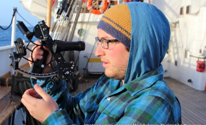 Orion Marker Marion takes a sighting aboard the U.S. Coast Guard Cutter EAGLE.