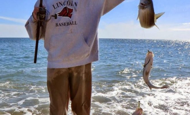 Jon Pickering hoists up a triple header that was landed on shrimp fly teasers and a Cocahoe on a jighead.