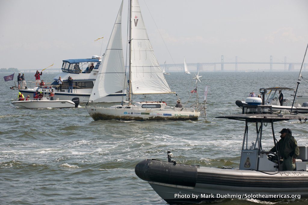 Matt Rutherford steers his boat, Saint Brendan, through a fleet of fans welcoming him home after his solo, non-stop voyage.
