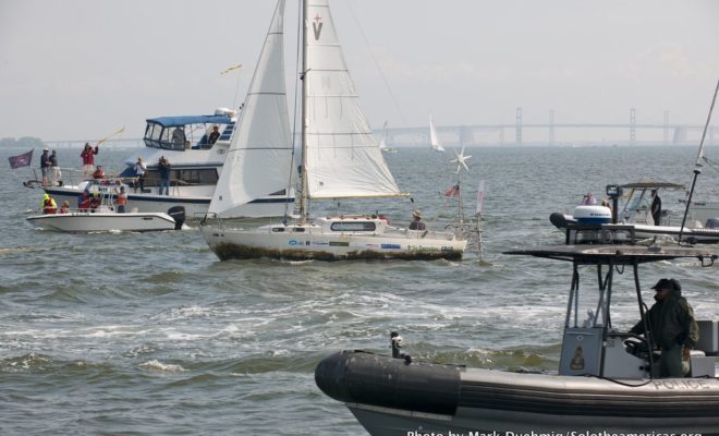 Matt Rutherford steers his boat, Saint Brendan, through a fleet of fans welcoming him home after his solo, non-stop voyage.