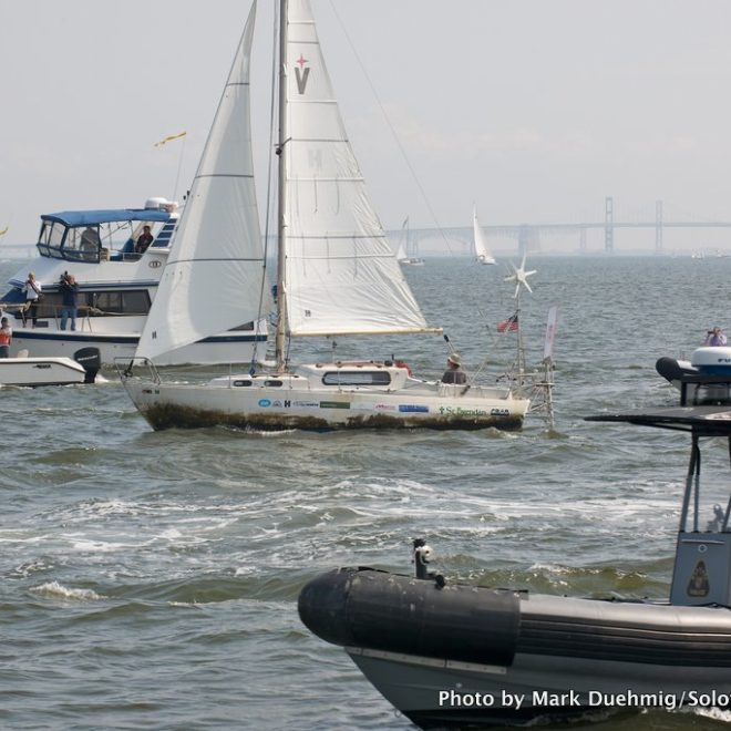 Matt Rutherford steers his boat, Saint Brendan, through a fleet of fans welcoming him home after his solo, non-stop voyage.