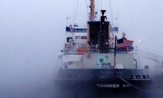 The Coast Guard icebreaker THUNDER BAY sits amid the sea smoke at Tilson's Wharf in Rockland.