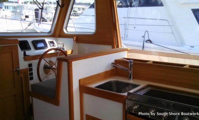 TWIST's interior includes a galley with European appliances.South Shore Boatworks owner and master builder Bob Fuller, at right, chats with TWIST's new owner.TWIST is lifted onto a transport ship in Newport, RI, bound for Genoa, Italy.