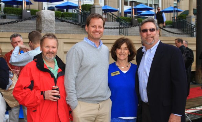 Aaron Crawford, COO of Sabre Yachts, at center, is joined by Rhonda and Michael Myers.