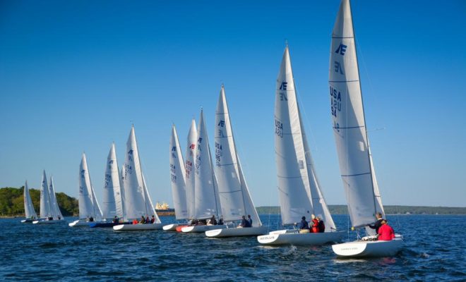 Seventeen Etchells from Fleet 27 crossing the starting line at the start of another great Tuesday evening of racing.