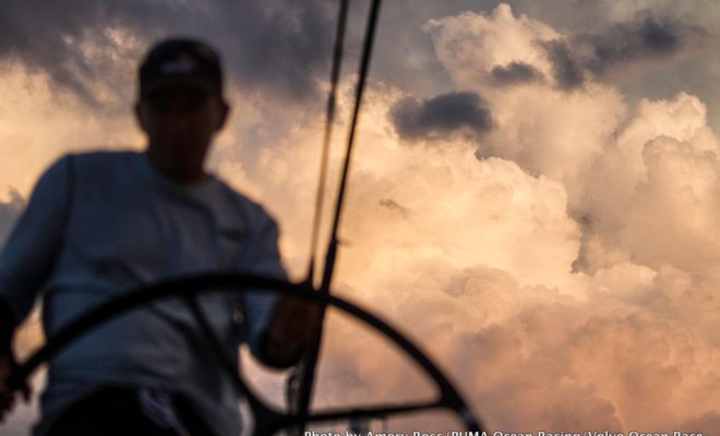 Kelvin Harrap drives under growing thunderclouds onboard MAR MOSTRO, skippered by Newport's Kenny Read.