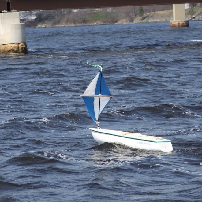 A mini-boat under sail in Belfast Harbor.