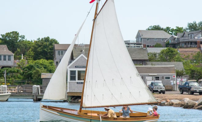 A small gaff rigged sloop heads out for an afternoon sail.