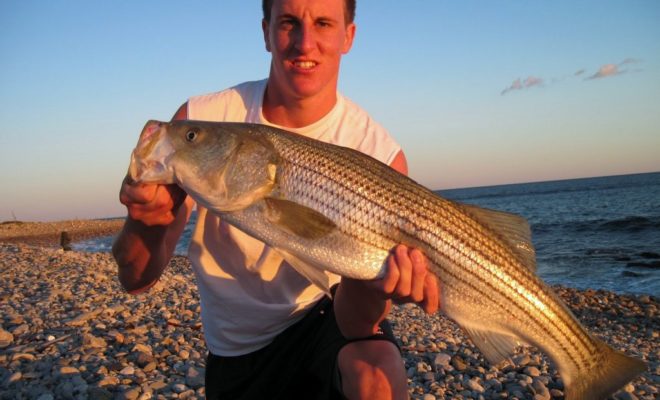 My son, Jon, with a nice 32-inch striper caught on a small swimmer.