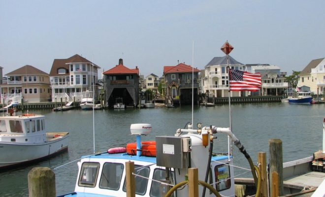 Two old boathouses sit amid new construction in Clam Creek. Boats here include commercial, luxury, and pleasure yachts.