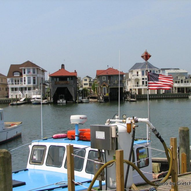 Two old boathouses sit amid new construction in Clam Creek. Boats here include commercial, luxury, and pleasure yachts.