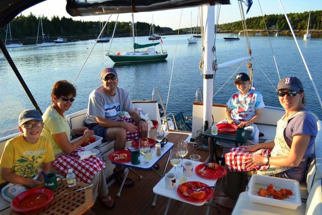 Three generations of the Thuotte family enjoy a lobster bake aboard CONTRAILS in Sebasco Harbor.