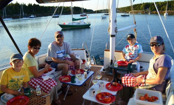 Three generations of the Thuotte family enjoy a lobster bake aboard CONTRAILS in Sebasco Harbor.