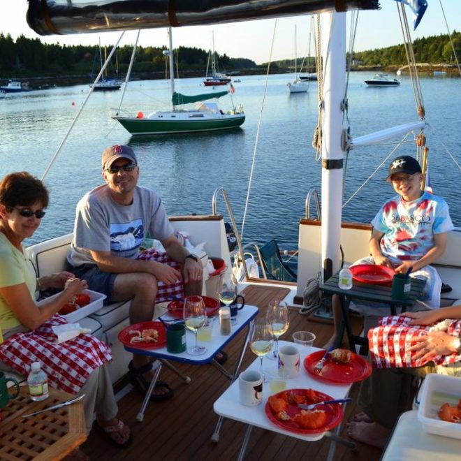 Three generations of the Thuotte family enjoy a lobster bake aboard CONTRAILS in Sebasco Harbor.