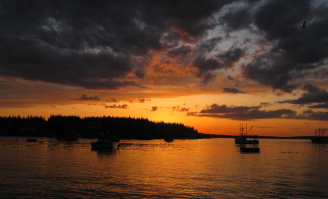 A fiery spring evening lights up Port Clyde Harbor and Hupper Island.