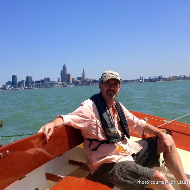 The proud new owner of BLOSSOM, a Pisces 21 built by Classic Boat Shop, at the helm on Lake Erie.