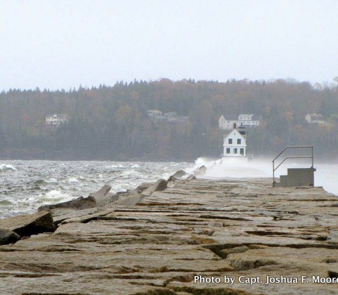 Just before the morning high tide, waves were crashing over the Rockland breakwater. With the storm surge, they overtopped it.
