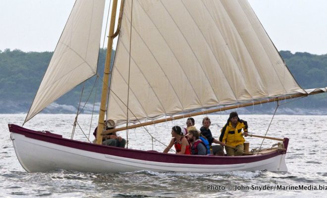 Reefed down, a new whaleboat for the CHARLES W. MORGAN makes its way into Newport Harbor on June 26.