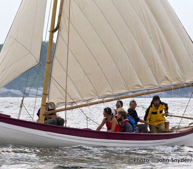 Reefed down, a new whaleboat for the CHARLES W. MORGAN makes its way into Newport Harbor on June 26.