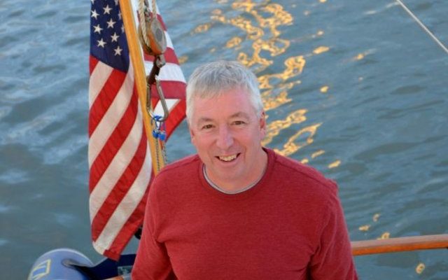 Vic Thuotte poses while CONTRAILS is secure at a mooring in Boothbay Harbor.