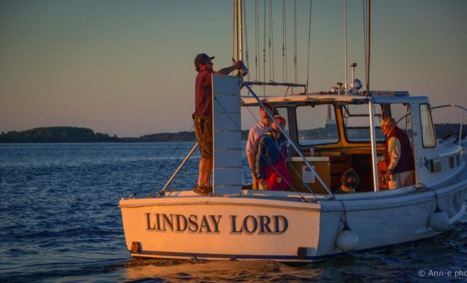 The PYC race committee wraps up its service for the evening and heads to shore to join the festivities.