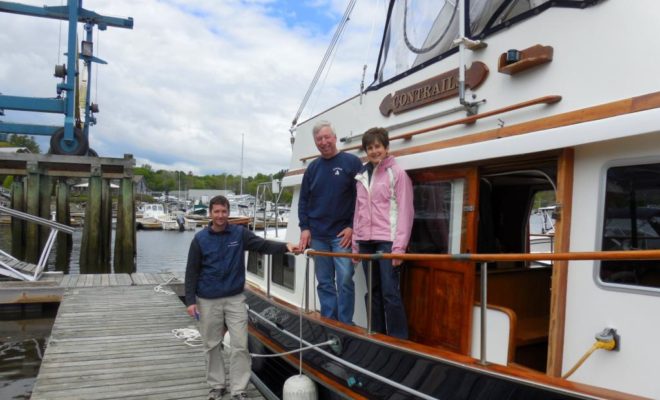 Project Manager Mike Day, at left, stands with Vic and Connie Thuotte as they prepare to depart Yankee Marina and Boatyard.