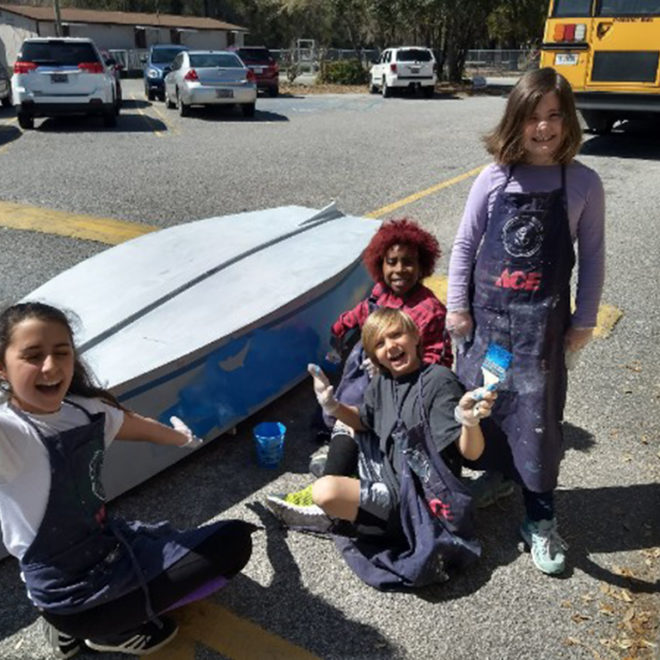 South Carolina kids painting a boat