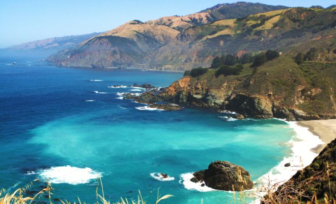 The coast in Central California is dramatic and beloved by surfers and beach-goers alike. By catlin.wolfard, CC BY-SA 3.0, https://commons.wikimedia.org/w/index.php?curid=53174213