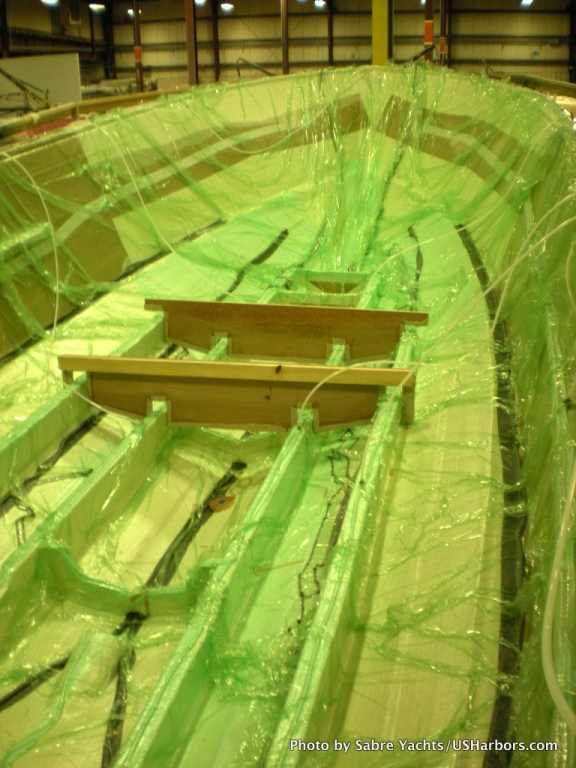 Once all core and dry fiberglass is installed, resin-distribution lines are run and a plastic sheet seals the assembly