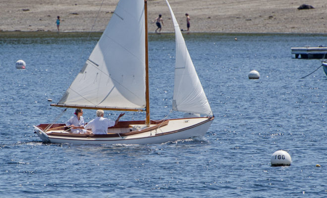 Buzzard's Bay 14 sails past Laite Beach in Camden, Maine.
