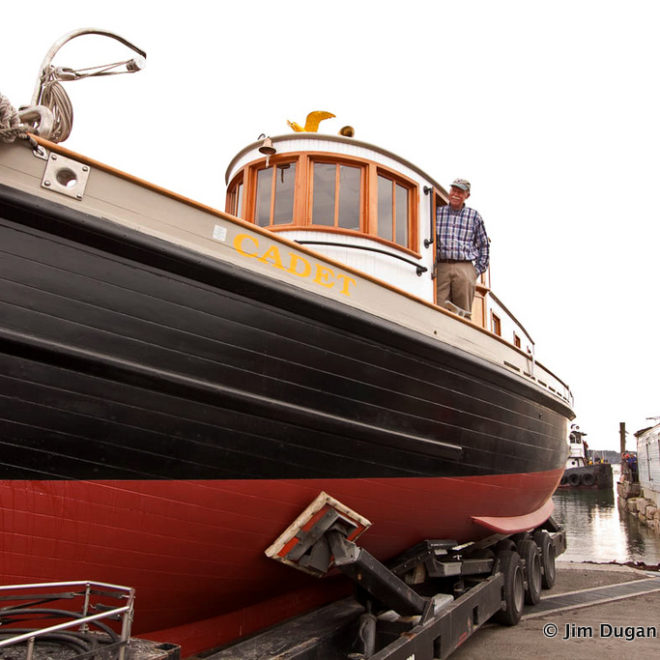 Capt. John Foss stands aboard the tugboat Cadet, which he rebuilt over a 10-year period.